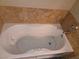 A close-up of the white, jetted bathtub with a marble tile surround at 9000 Las Vegas Blvd # 2101, Las Vegas, NV 89123
