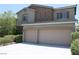 Charming two-story home featuring a two-car garage and stone accents on the upper level at 9065 Mastodon Ave, Las Vegas, NV 89149