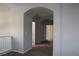 Hallway featuring arched entryways, carpeting, and neutral paint scheme at 9065 Mastodon Ave, Las Vegas, NV 89149