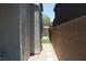 Narrow side yard with a stone pathway and artificial turf, offering low-maintenance landscaping at 9065 Mastodon Ave, Las Vegas, NV 89149