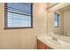 A well-lit bathroom features a mirror and a window with privacy blinds at 9626 Grapeland Ave, Las Vegas, NV 89148