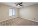 A well lit bedroom with a ceiling fan and carpet at 9626 Grapeland Ave, Las Vegas, NV 89148