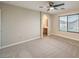 Spacious carpeted bedroom with ceiling fan, large window, and bathroom access at 9626 Grapeland Ave, Las Vegas, NV 89148