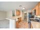 A kitchen with light wood cabinets and stainless steel appliances and laundry room access at 9626 Grapeland Ave, Las Vegas, NV 89148