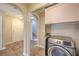 Pass through laundry area with tile floor, washer and shelving at 9626 Grapeland Ave, Las Vegas, NV 89148