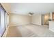 Bright living room features an open floor plan, a ceiling fan, neutral walls, and carpet floors at 9626 Grapeland Ave, Las Vegas, NV 89148