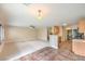 A spacious living room with tile and carpet and adjoining eat-in kitchen at 9626 Grapeland Ave, Las Vegas, NV 89148