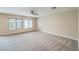 Spacious living room features neutral paint, carpet, ceiling fan and natural light at 9626 Grapeland Ave, Las Vegas, NV 89148