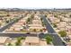 Areal view of a neighborhood, with tan stucco homes, paved streets, and various trees at 9626 Grapeland Ave, Las Vegas, NV 89148