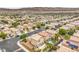 Expansive view showcasing a neighborhood filled with stucco homes, lush green trees, and paved streets at 9626 Grapeland Ave, Las Vegas, NV 89148