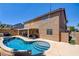Backyard showcasing a pool and spa, with covered patio and lush landscaping at 98 Milicity Rd, Henderson, NV 89012