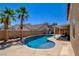 Relaxing backyard view features a sparkling blue pool, spa, and shady palm trees at 98 Milicity Rd, Henderson, NV 89012