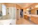 Bright bathroom with a tiled floor, shower, and double vanity featuring a vanity at 98 Milicity Rd, Henderson, NV 89012
