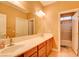 Bathroom featuring double sink vanity with tile floors, marble countertop, and a framed mirror at 98 Milicity Rd, Henderson, NV 89012