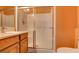Well-lit bathroom with a glass-enclosed shower, sink with vanity, and standard toilet at 98 Milicity Rd, Henderson, NV 89012