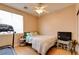 Bright bedroom featuring a comfy bed, ceiling fan, and adjacent treadmill for easy access to fitness at 98 Milicity Rd, Henderson, NV 89012