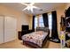 Bright bedroom featuring carpet flooring, ceiling fan, and black-out curtains over dual windows at 98 Milicity Rd, Henderson, NV 89012