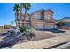 Inviting two-story home with manicured landscaping, rock groundcover and a charming side yard at 98 Milicity Rd, Henderson, NV 89012