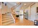 Inviting foyer showcasing a grand staircase, hardwood floors, and an open view into the living area at 98 Milicity Rd, Henderson, NV 89012