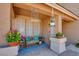 Charming front porch with a cozy seating area, decorative plants, and stylish decor at 98 Milicity Rd, Henderson, NV 89012