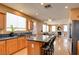 This open kitchen features stainless appliances, granite countertops, a kitchen island and opens to the living room at 98 Milicity Rd, Henderson, NV 89012