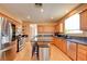 This open kitchen features stainless appliances, granite countertops, a kitchen island and wood cabinets at 98 Milicity Rd, Henderson, NV 89012