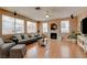 The spacious living room has hardwood floors, a fireplace, and large windows overlooking the backyard at 98 Milicity Rd, Henderson, NV 89012
