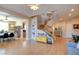 Open-concept living and dining area with hardwood floors, open staircase, and neutral décor at 98 Milicity Rd, Henderson, NV 89012