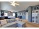 Huge main bedroom with a gray sectional sofa, bed, and curated decorations and lots of natural light at 98 Milicity Rd, Henderson, NV 89012