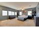Spacious main bedroom with an abundance of natural light, a cozy bed, and plenty of storage space at 98 Milicity Rd, Henderson, NV 89012
