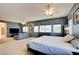 Oversized main bedroom showcasing lots of windows, stylish furniture, and an attached sitting area at 98 Milicity Rd, Henderson, NV 89012