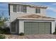 Charming two-story home with a well-manicured lawn, a gray exterior, and an attached two-car garage at 9912 Landings St, Las Vegas, NV 89141