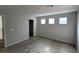 Spacious bedroom with neutral tones, carpet flooring, and three windows for natural light at 10449 Forked Run St, Las Vegas, NV 89178