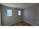 This is a neutral bedroom with carpet and two bright windows for natural light at 10449 Forked Run St, Las Vegas, NV 89178