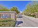 Inviting Quintessa community entrance with brick-paved road, landscaping, and clear signage at 10449 Forked Run St, Las Vegas, NV 89178