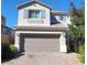 Charming two-story home with a well-maintained front yard and a two-car garage in a quiet neighborhood at 10449 Forked Run St, Las Vegas, NV 89178