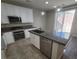 Bright kitchen featuring stainless steel appliances, a central island, granite countertops, and white cabinets at 10449 Forked Run St, Las Vegas, NV 89178