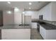 Modern kitchen features white cabinets, granite countertops, stainless steel appliances, and a central island at 10449 Forked Run St, Las Vegas, NV 89178