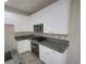 Well-equipped kitchen with white cabinets, granite countertops, stainless steel appliances, and tile backsplash at 10449 Forked Run St, Las Vegas, NV 89178