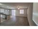 Open living room with wood-look floors, bright lighting, and kitchen access, ideal for modern living at 10449 Forked Run St, Las Vegas, NV 89178