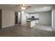 Spacious living area with wood-look flooring, neutral walls, and an open kitchen layout, creating a welcoming space at 10449 Forked Run St, Las Vegas, NV 89178