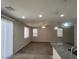 Bright, open space with wood-look floors, multiple windows, and modern pendant lights over the kitchen island at 10449 Forked Run St, Las Vegas, NV 89178