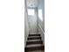 Carpeted stairs lead to the second floor with white railing and window at 10449 Forked Run St, Las Vegas, NV 89178