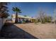 Spacious backyard with mature trees and desert landscaping, offering a blank canvas for customization at 1213 New Mexico St, Boulder City, NV 89005