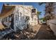 View of the side of a single-story home showcasing weathered wood siding and an external cooling unit at 1213 New Mexico St, Boulder City, NV 89005