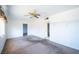 Bright living room featuring neutral walls, classic ceiling fan, and ample natural light at 1213 New Mexico St, Boulder City, NV 89005