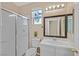 Bathroom with tiled shower, white vanity, and a window allowing natural light at 1557 Sabatini Dr, Henderson, NV 89052