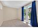 Bright bedroom with carpet, and large windows with view to green backyard at 1557 Sabatini Dr, Henderson, NV 89052