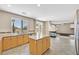 Beautiful open kitchen with an island, wooden cabinets, and seamlessly flowing into the living area at 1557 Sabatini Dr, Henderson, NV 89052