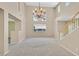 Spacious living room with carpet, high ceilings, lots of natural light, and a staircase at 1557 Sabatini Dr, Henderson, NV 89052